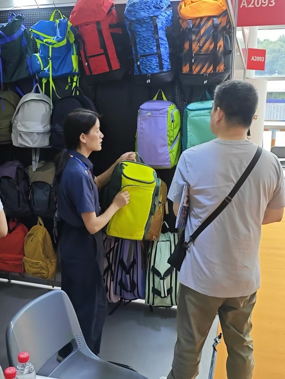 Staff showing a backpack to a visitor
